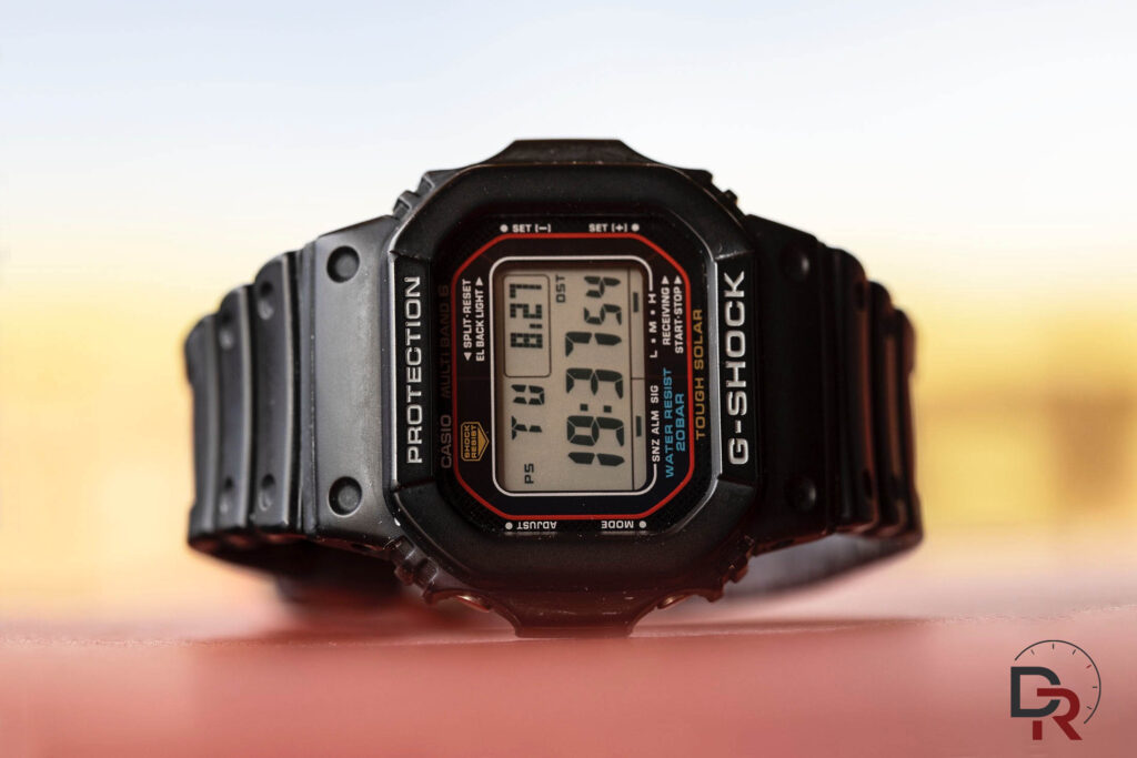 Casio G-Shock GW-M5610 with traditional red frame on neutral background
