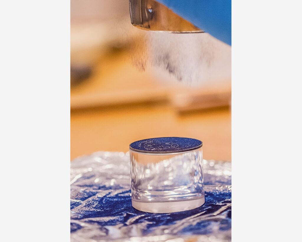 Sifting dry enamel powder over watch dial