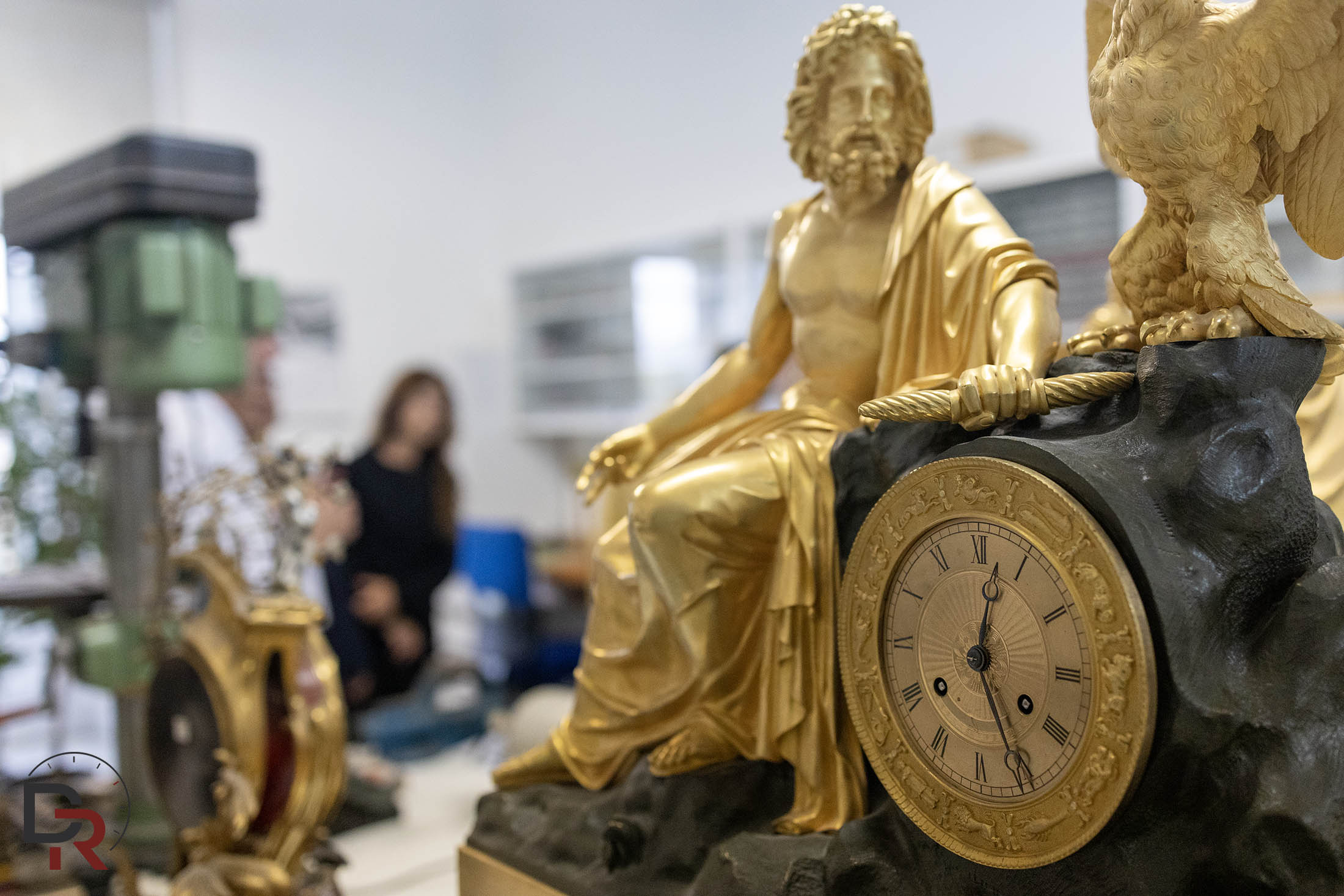 Gilt-bronze mantel clocks undergoing restoration in the Royal Palace workshop